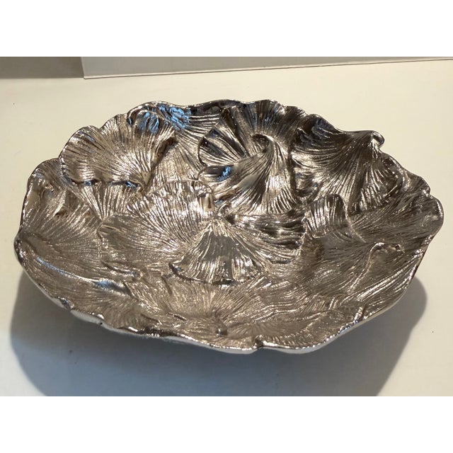 Small nut bowl / catchall in silver toned metal with gingko leaf motif by Michael Aram. Fun little bowl for styling or...