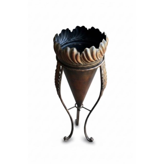 Decorative vintage floor planter or jardinière featuring an elegant tall tripod form with a tapered conical planter and...