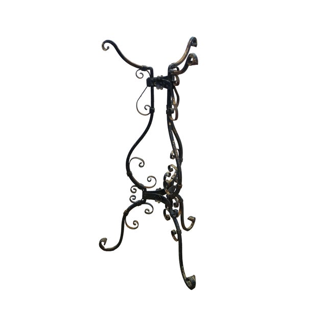 This striking Victorian wrought iron jardinière stand features an intricate Art Nouveau influenced design characterized by...