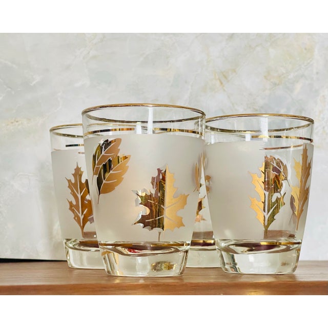 A set of four gold trimmed juice glasses and decorated with stylized leaves. Ships within 1-2 days using USPS. All items...