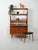 1950s–60s teak bookcase with sliding doors, adjustable shelves, and two small suspended drawers. Tapered legs. Clean lines...