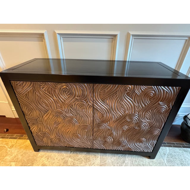 A Masterwork by Renowned Chinese-American Artist Robert Kuo, Atrributed This exceptional "Dragon Swirl" bar cabinet...