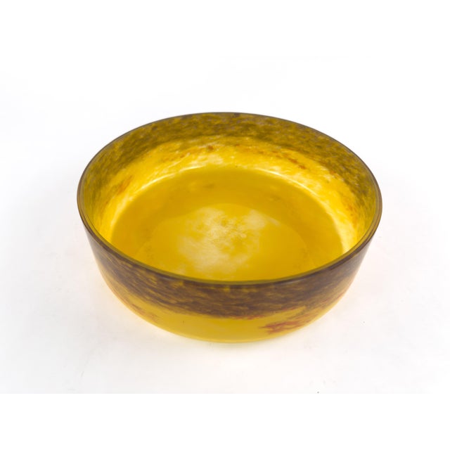 An elegant French Art Deco centerpiece pairs a luminous marbled glass bowl by Degué with an ornate wrought iron mount...