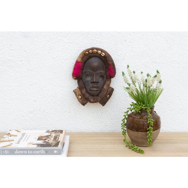 This enigmatic Dan mask from the Ivory Coast is a captivating example of African tribal art. The mask is characterized by...