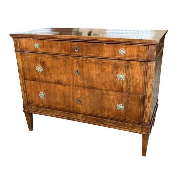 Neoclassical commode handmade in Italy in the early 1800s or late 1700s using fruit wood and decorated with walnut veneer...