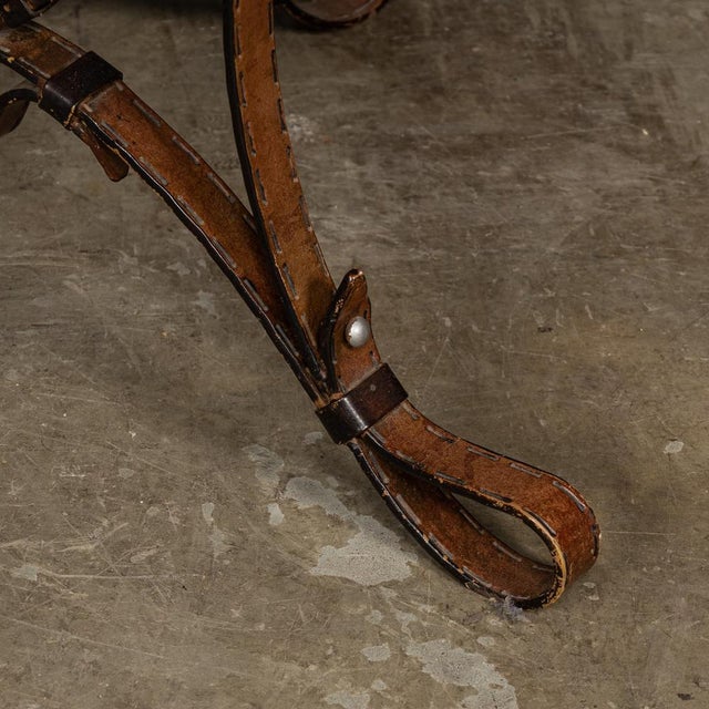 A superb late-20th Century coffee table featuring cold painted wrought iron straps meticulously crafted with intricate...