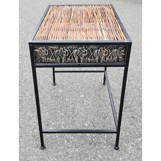 Showcasing a beautifully crafted bamboo top paired with a sleek black metal frame, this striking safari side table...
