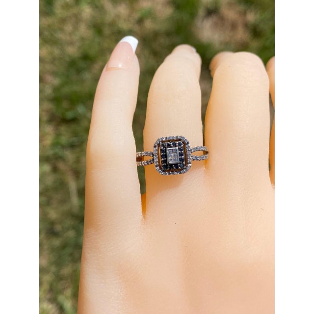 The San Fernando: Black and White Diamond Halo Ring. Featured in the center are white diamonds surrounded by a black...