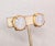 1960s round goldtone with prong set round white iridescent raised pattern rhinestone center clip earrings with comfort...