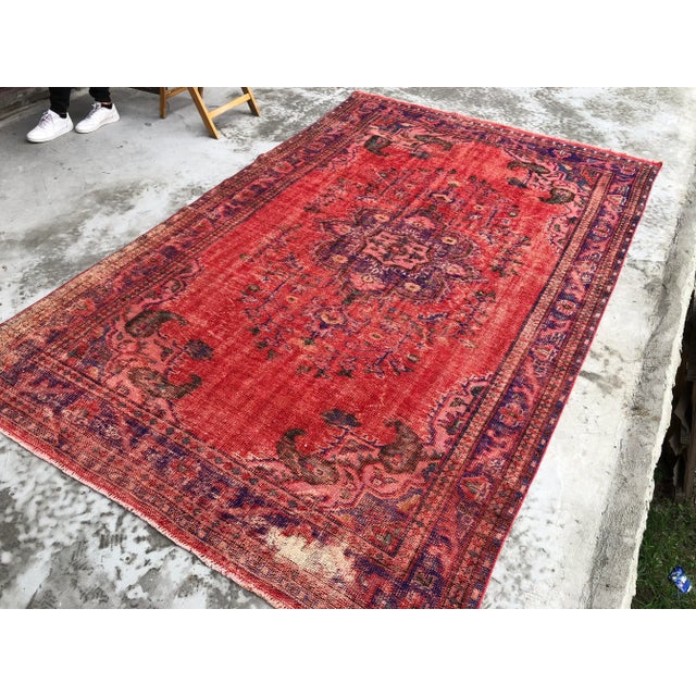 This is a vintage Turkish Oushak rug from the 1960s. The piece was hand-knotted.