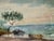 Antique watercolor coastal landscape featuring a shoreline scene with a tree, small boat, rocks, water, and birds in the...