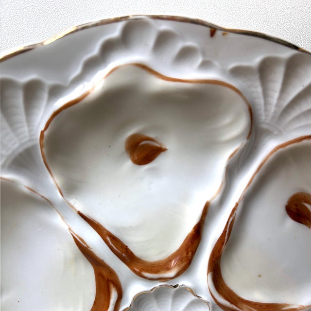 Capture the charm of Victorian-era dining with this antique porcelain oyster plate, dating from circa 1880–1910. This...