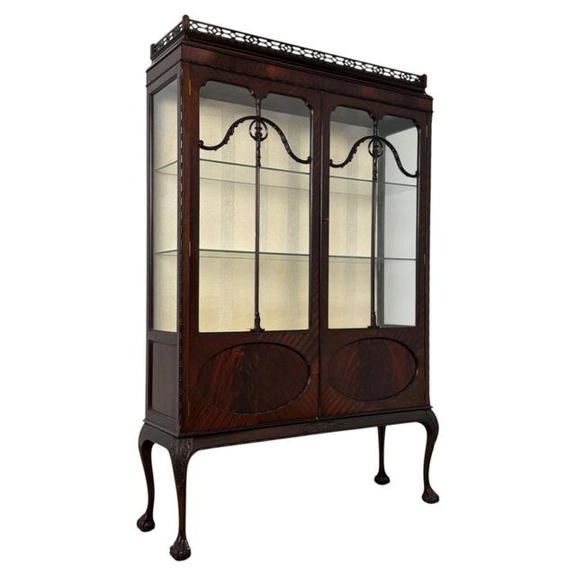 An impressive early 20th-century mahogany display cabinet by Morgan & Co., finely crafted in the Chippendale style and...