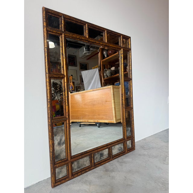 Striking Hollywood Regency faux bamboo mirror featuring a richly detailed tortoise shell finish. This statement piece...