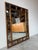 Striking Hollywood Regency faux bamboo mirror featuring a richly detailed tortoise shell finish. This statement piece...
