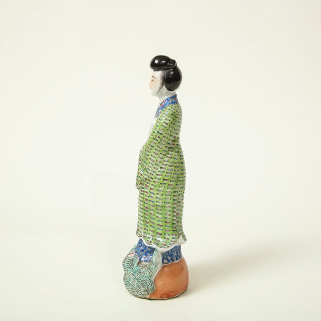 Dressed in finely enameled robes and carrying a scroll; on a stylized wave base. Provenance: From the Collection of Mario...