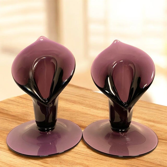 This matched pair of unmarked amethyst art-glass Jack-in-the-Pulpit bud vases dates to approximately the turn of the...