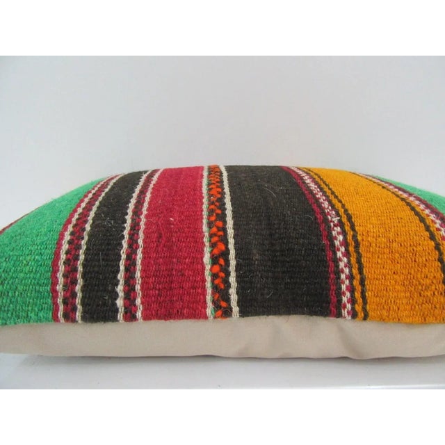 This is a pillow cover made from a vintage kilim rug. The piece was properly washed and ready to use. Pillow inserts not...