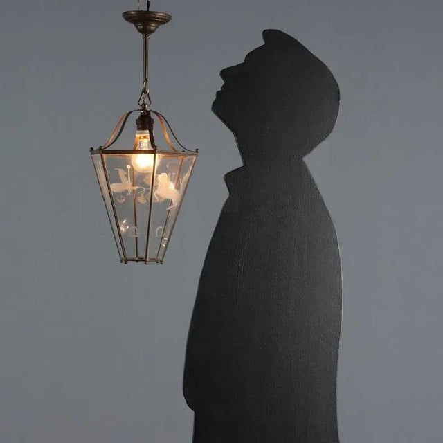 Inverted pyramid-shaped lantern with a hexagonal section, burnished metal structure, glass engraved with zodiac signs, one...