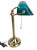 A classic banker's desk lamp featuring a brass-tone metal base and adjustable arm paired with a glass shade in a blue-...