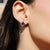 Crafted in 925 sterling silver, these elegant stud earrings feature 2 natural Iolite gemstones in a striking square shape,...