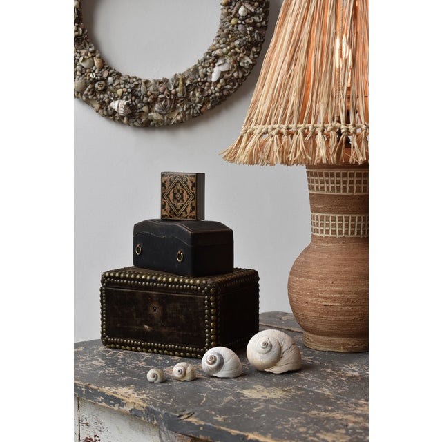 Vintage Sculpted Leather Box Made in Italy, Circa Mid-20th Century. The black rectangular leather box incorporates an...