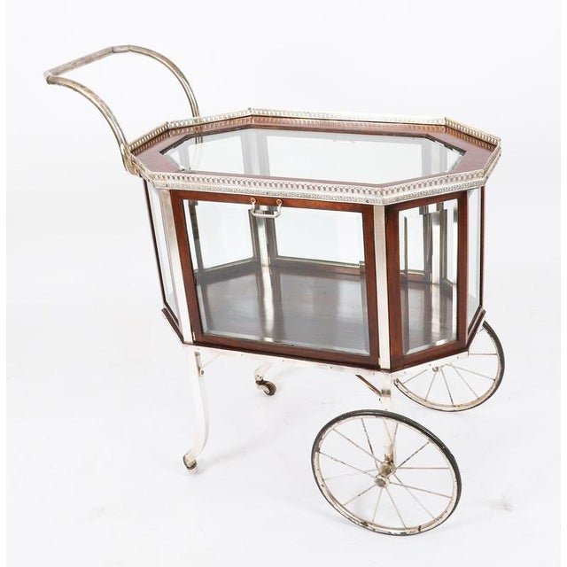 This is a striking and rare antique French Art Deco Gilt and glass bar cart, circa 1920 in date. The cart features an...