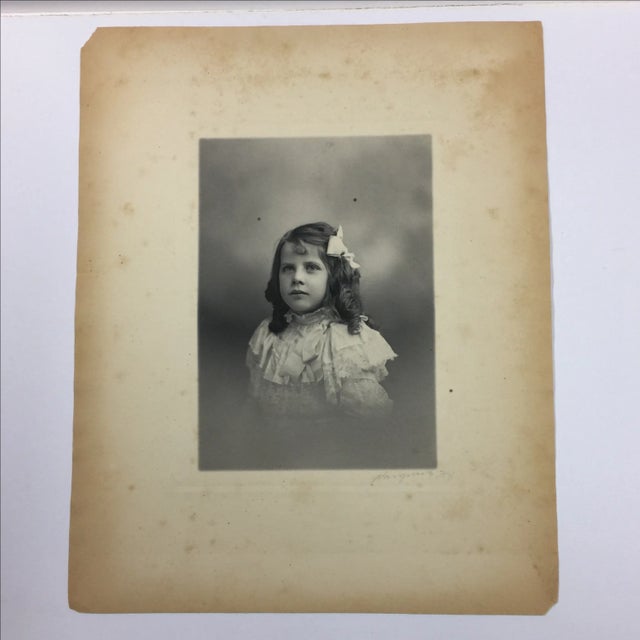 Made by Hargrave's, 402 Fifth Avenue, New York. This photograph is a portrait of a young girl in a frilled dress. Signed...