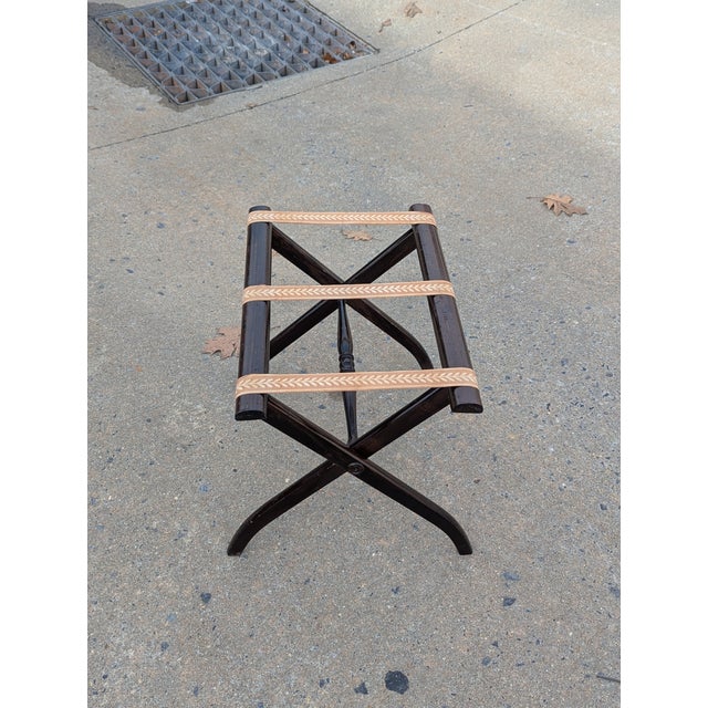 Ideal for any bedroom or walk-in closet, this luggage rack combines elegance with utility. It features a dark finish solid...