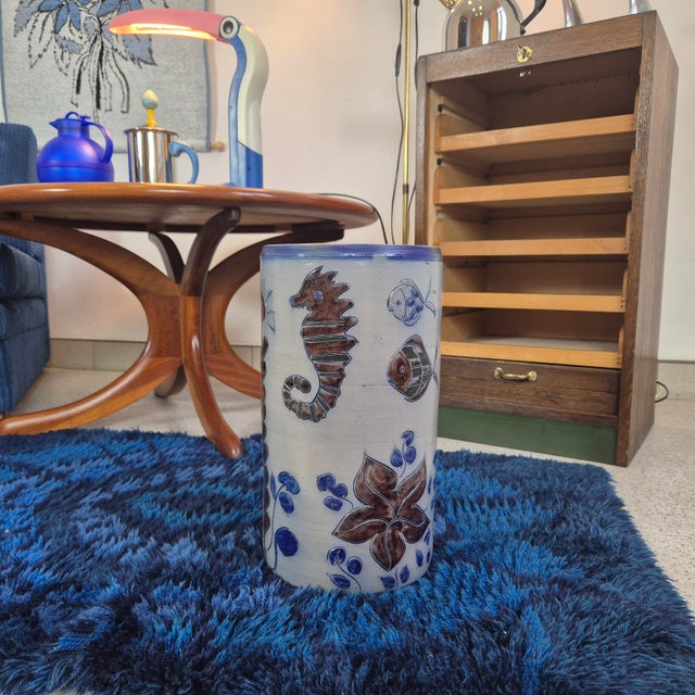 The piece is decorated with richly detailed hand-painted relief motifs inspired by the underwater world. Stylized fish, a...