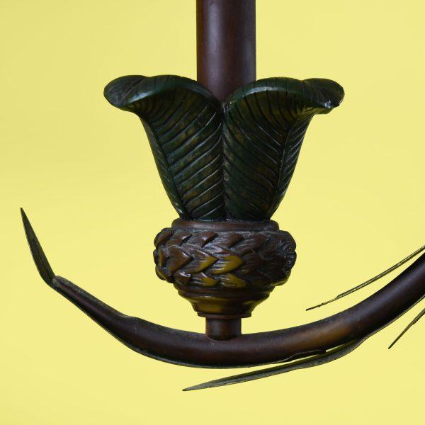 A vintage palm tree chandelier with a monkey — the ultimate Palm Beach fixture, fronds arching overhead while a playful...