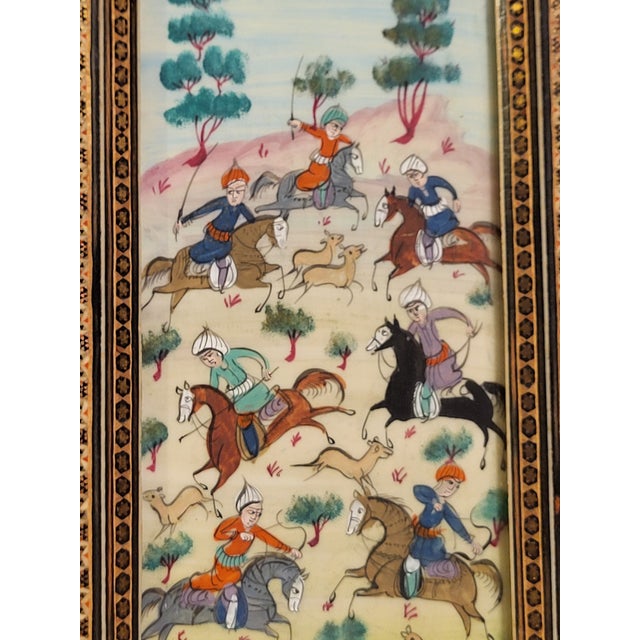 Framed PersianGauche painted warriors on horseback riding swordsman and spearmen. Mounted in a gilt frame under glass and...