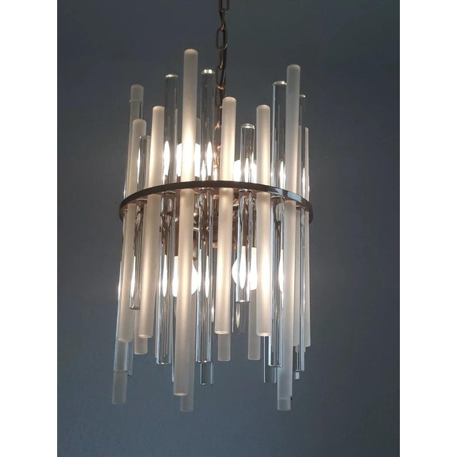 Christopher Palme Object: 4-bulb hanging lamp, e27 Age: circa 1970s Color/Material: Brass, glass The glass rods have a...