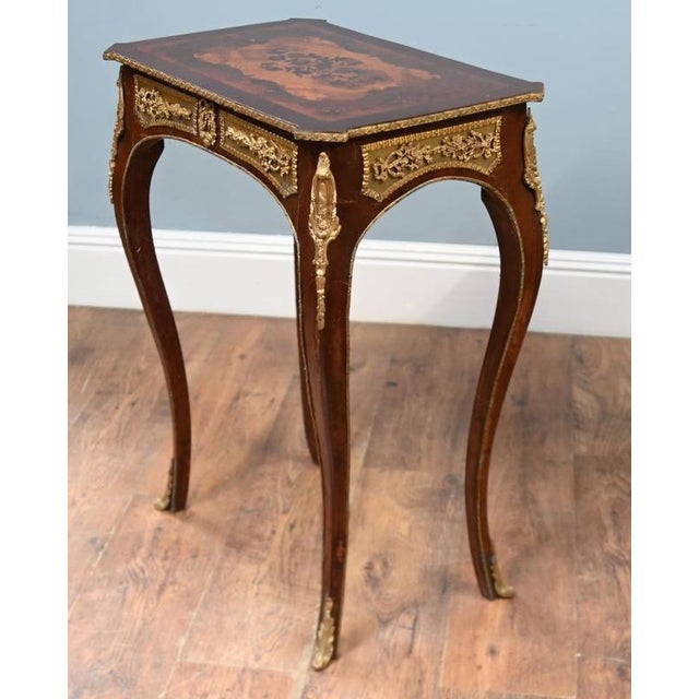 A decorative pair of Louis XV style side tables with shaped tops and floral marquetry inlay The tops are framed by...