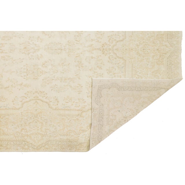 This stunning Antique Persian Kerman wool rug is a masterpiece of understated luxury. Featuring a traditional medallion-...