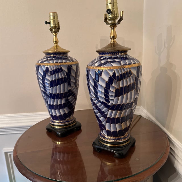 Pretty and unusual pair of Asian style abstract paired ceramic lamps. Abstract Hand painted design with brass like borders