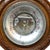 An antique aneroid barometer from the late Victorian era, dating to circa 1900. This scientific instrument is housed in a...
