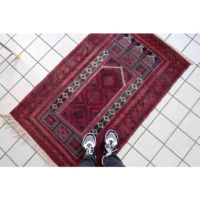 Handmade vintage Afghan Baluch rug in red and night blue colors. The rug is from the beginning of 20th century, it is in...