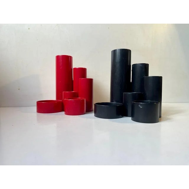 A red and a black pencil-holder in cast acrylic. 1970s modern architectural styling. Designed and manufactured by pentex...