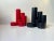 A red and a black pencil-holder in cast acrylic. 1970s modern architectural styling. Designed and manufactured by pentex...