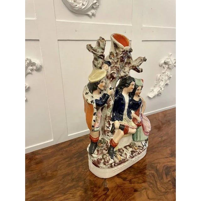 Antique 19th century staffordshire flatback figure with a spill vase to the top depicting two lovers in period costume...