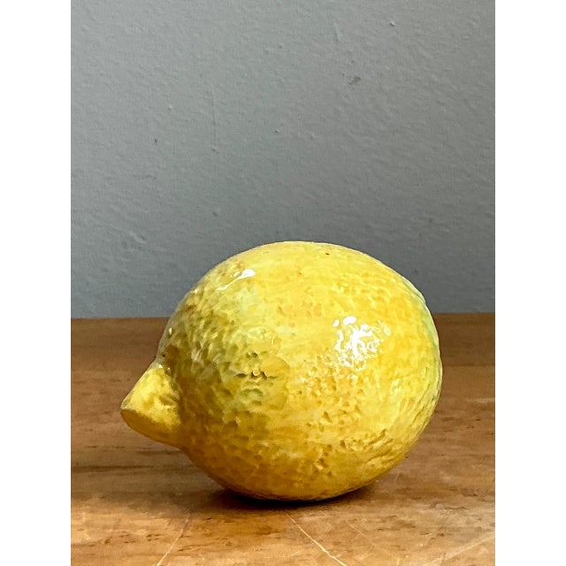 This vintage Italian ceramic lemon embodies the mid-20th century Italian decorative arts tradition, prized for its...