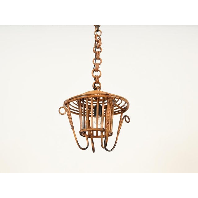 Marvelous mid-century french riviera style pendant made from a gorgeous combination of curved rattan, bamboo, and hand-...