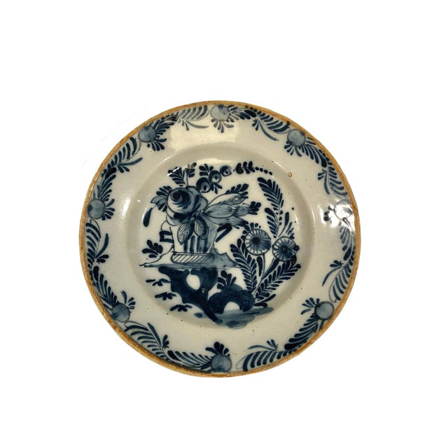 An 18th century Delft plate with classic blue and white florals.