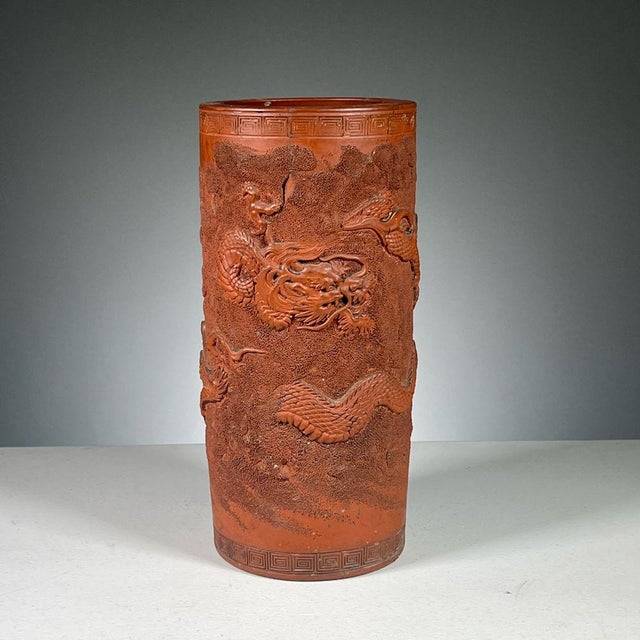 An antique Japanese terracotta brush pot decorated with a sinuous dragon and cloud in high relief. Product Information:...