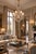 An elegant french louis xv style metal and cut- crystal nine-light chandelier. The caged body surmounted with 9 scrolled...