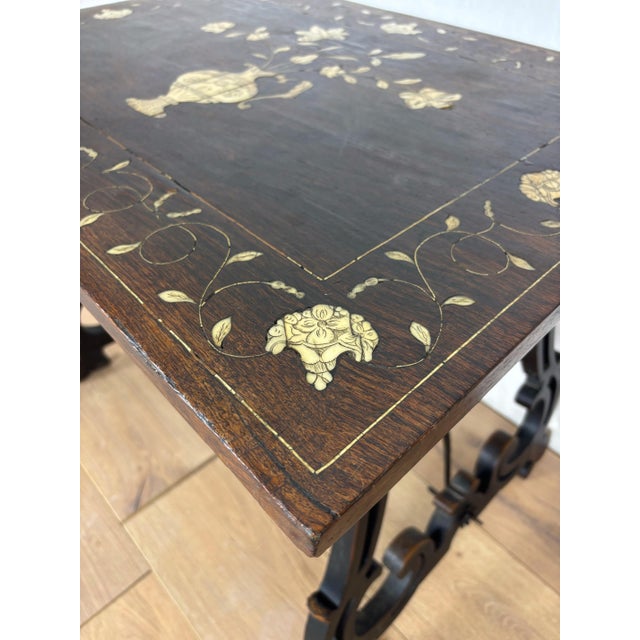 Elegant Spanish Baroque style side table featuring a richly decorated marquetry top with floral inlay centered by an urn...