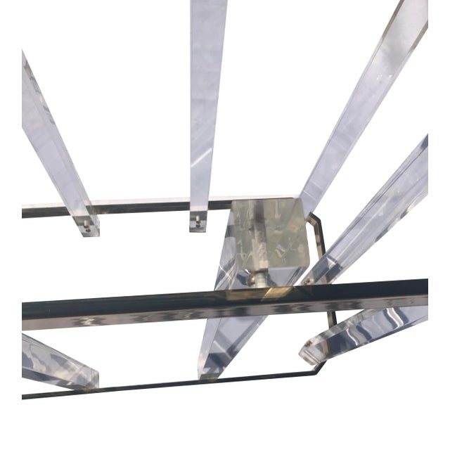 Popular 80’s style lucite console table with glass top designed by Charles Hollis. Clear legs with brass upper and lower...