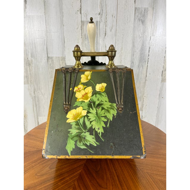 Beautiful tole painted floral design on the front of the coal bucket with matching shovel.