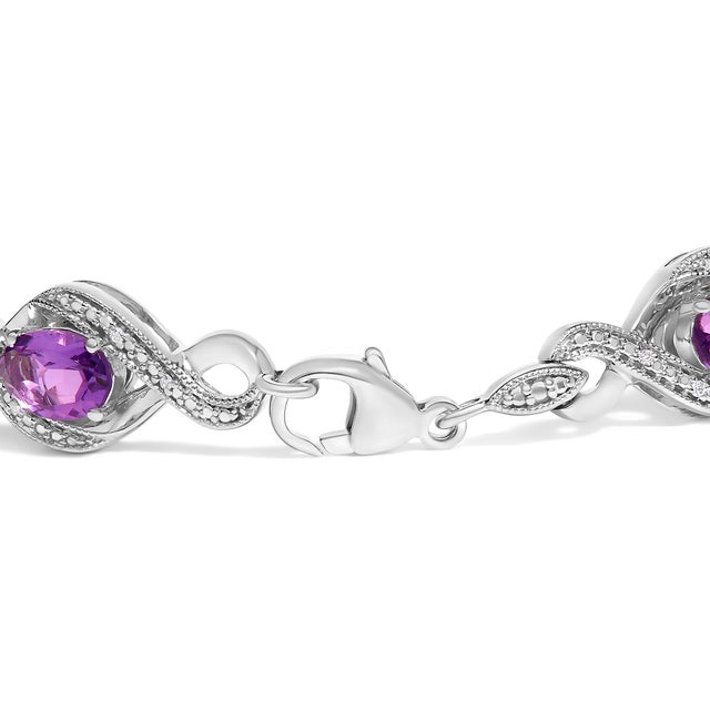 Immerse yourself in the ethereal elegance of this exquisite bracelet, where the timeless allure of .925 sterling silver is...